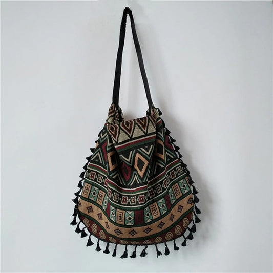 Boho Shoulder Bag in the color Diamond green hanging on a white wall