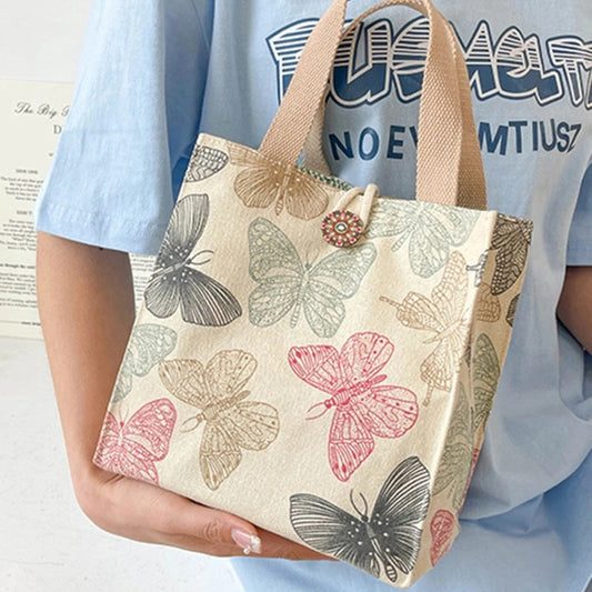 Butterfly Tote Bag in size large held from a woman in a blue t-shirt